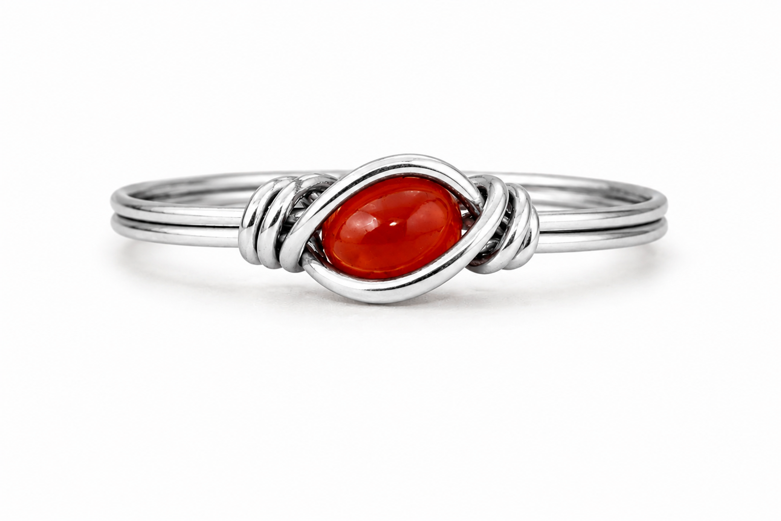 A silver ring featuring a polished oval red gemstone in the center, surrounded by a twisted wrap design on a clean white background.