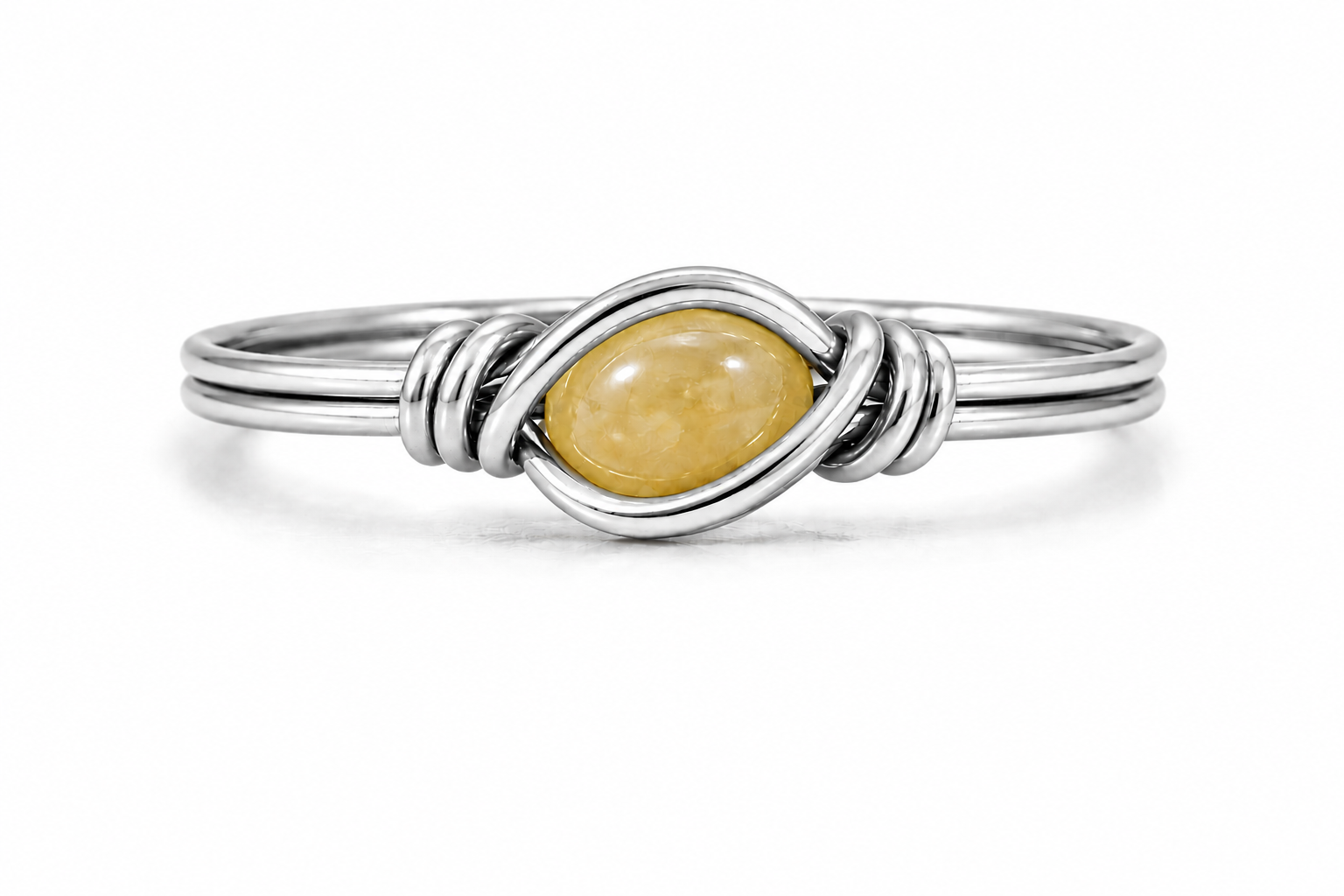A silver ring featuring a twisted wrap design around a smooth, oval yellow gemstone, set against a plain white background.